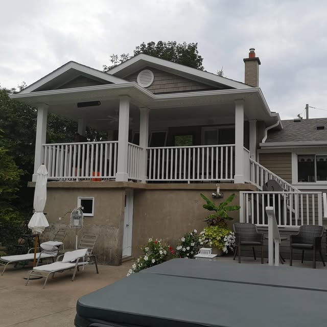 Exterior deck and stairs with painted railings beside a home
